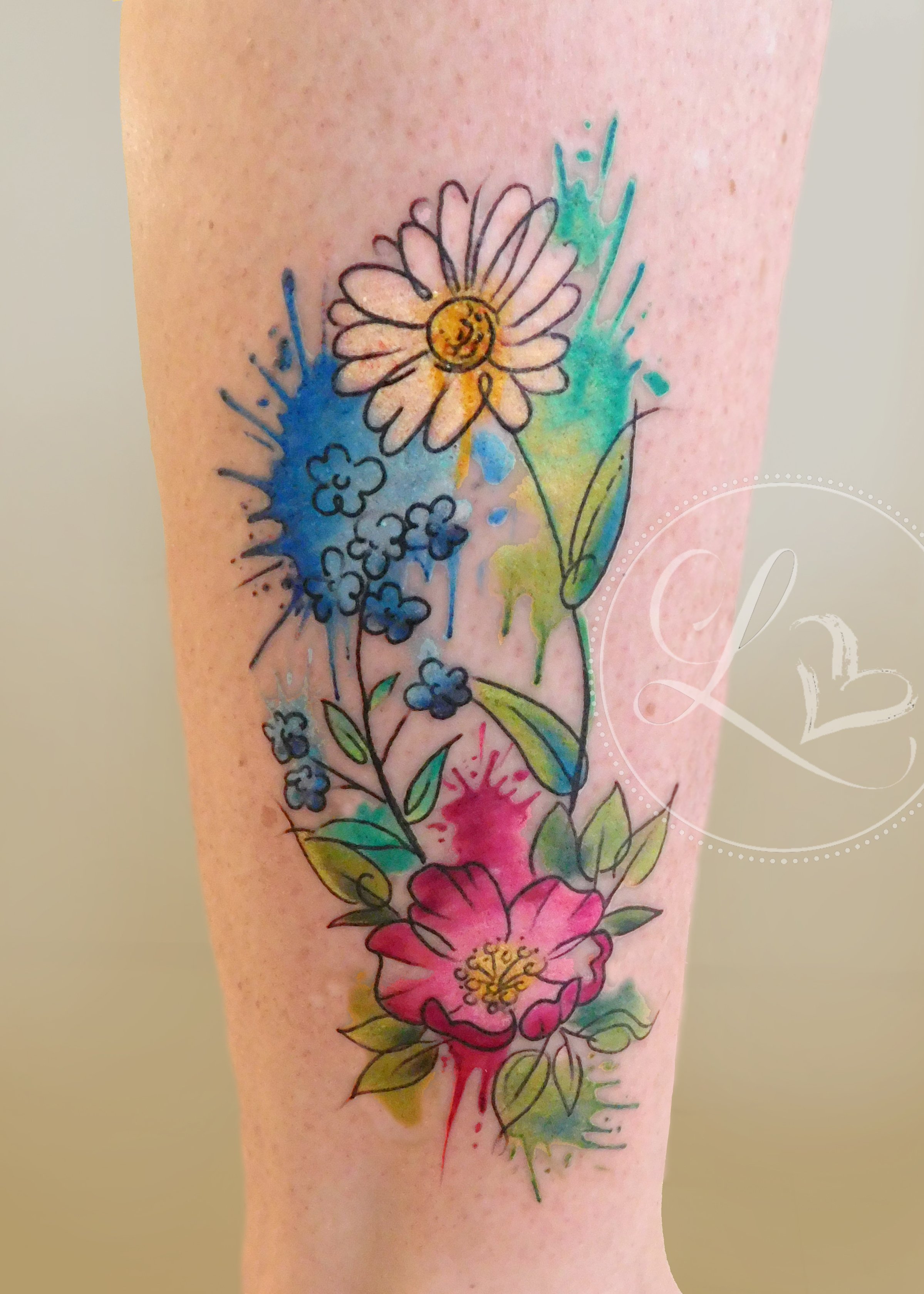 Watercolor style colorful floral bouquet on a leg featuring a daisy, forget me not, and dogwood rose