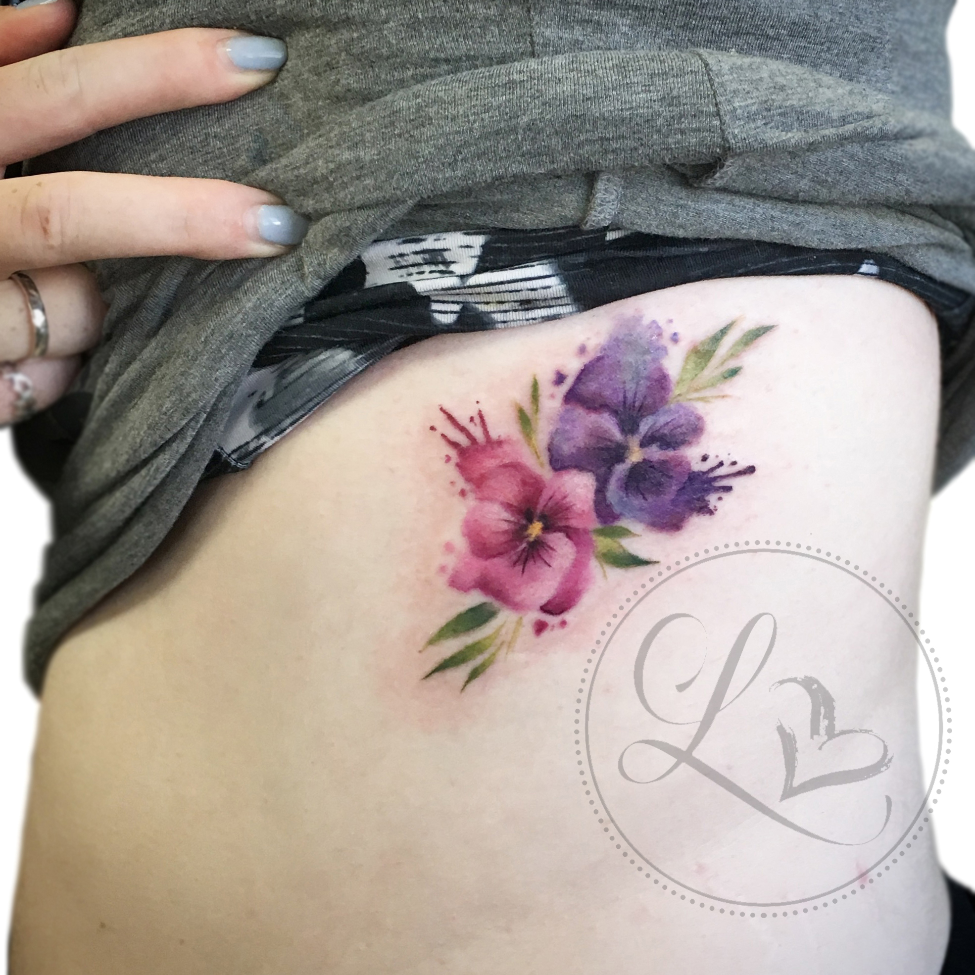 Watercolor pansy floral tattoo on the ribs
