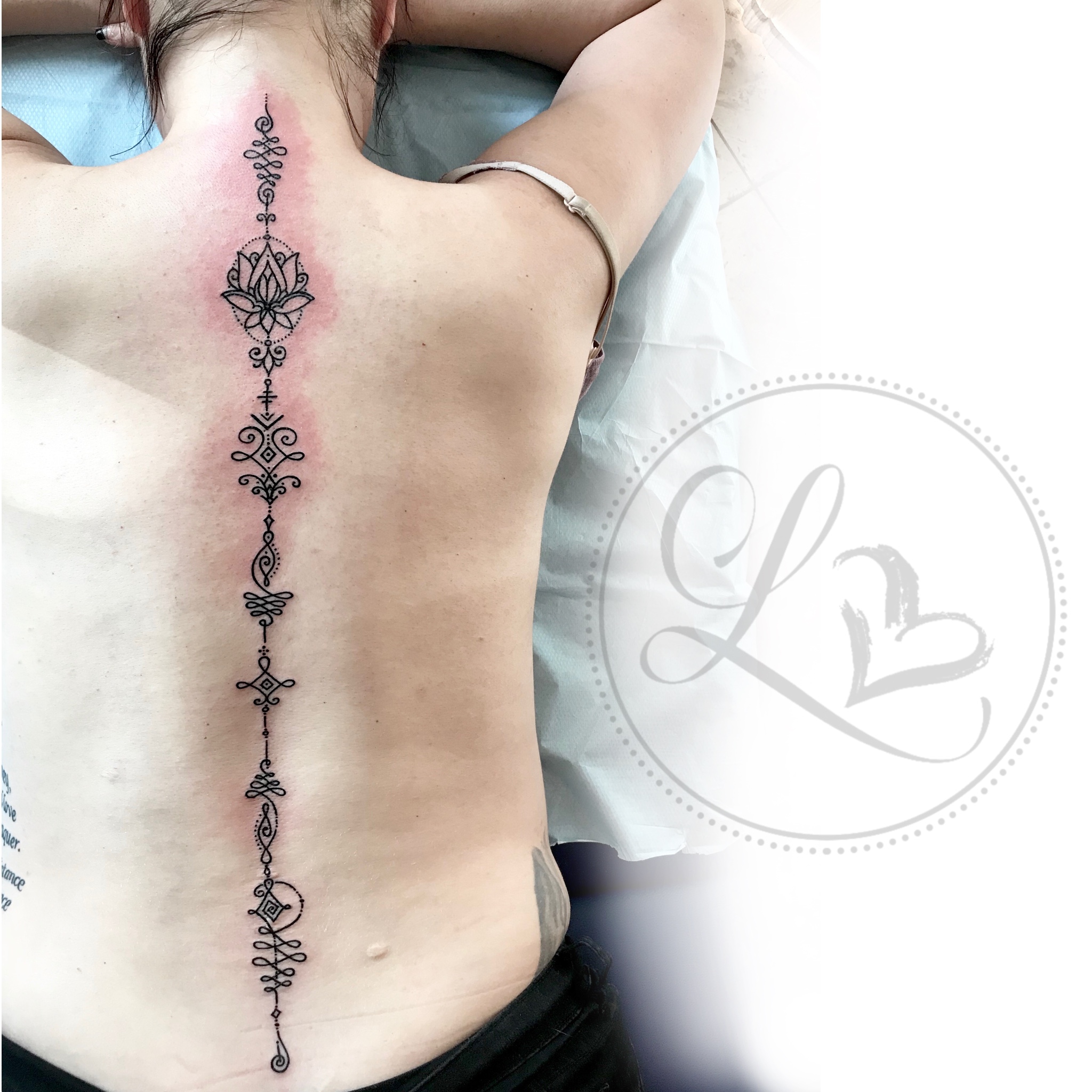 henna unalome linework spine tattoo