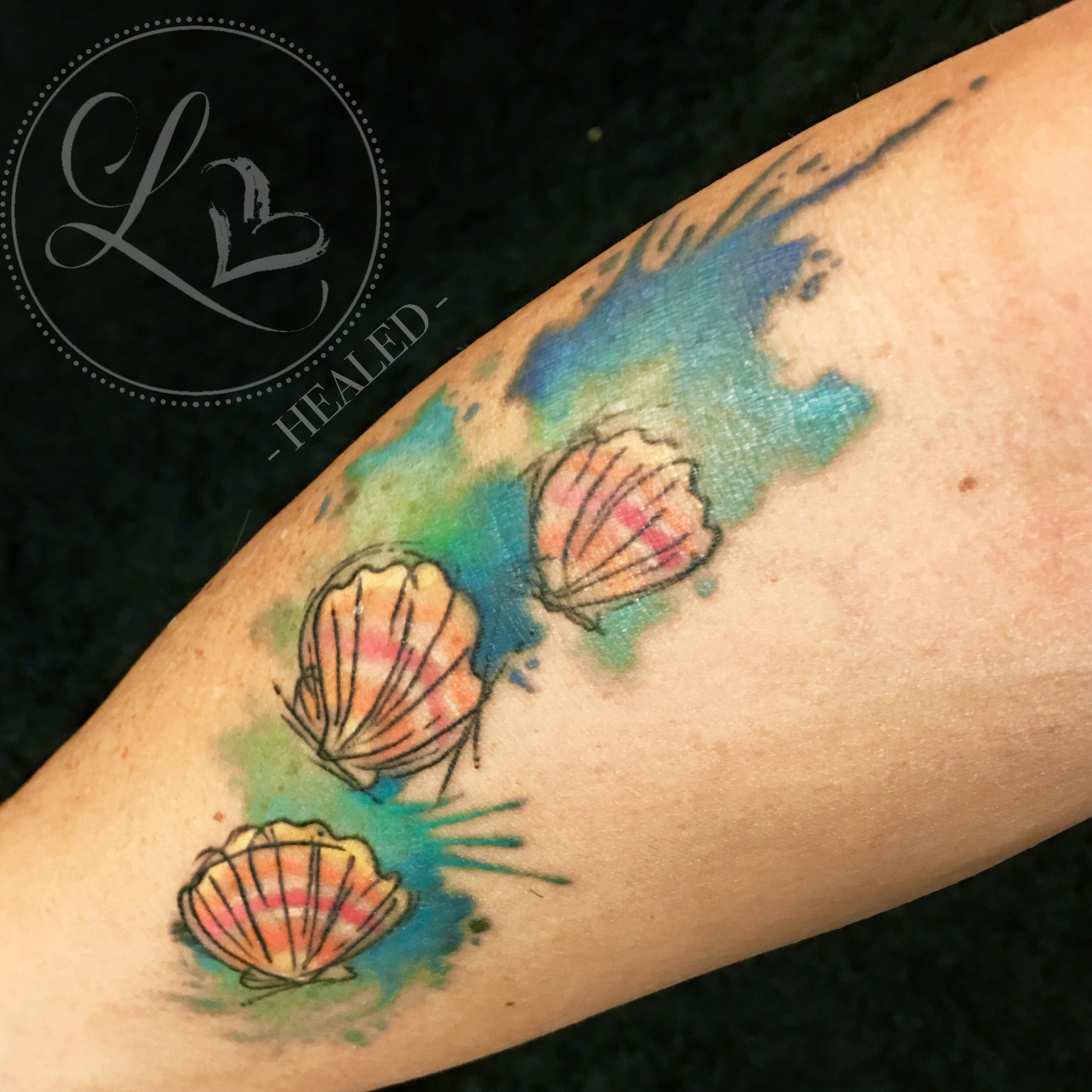Healed tattoo of sunrise shells in watercolor style