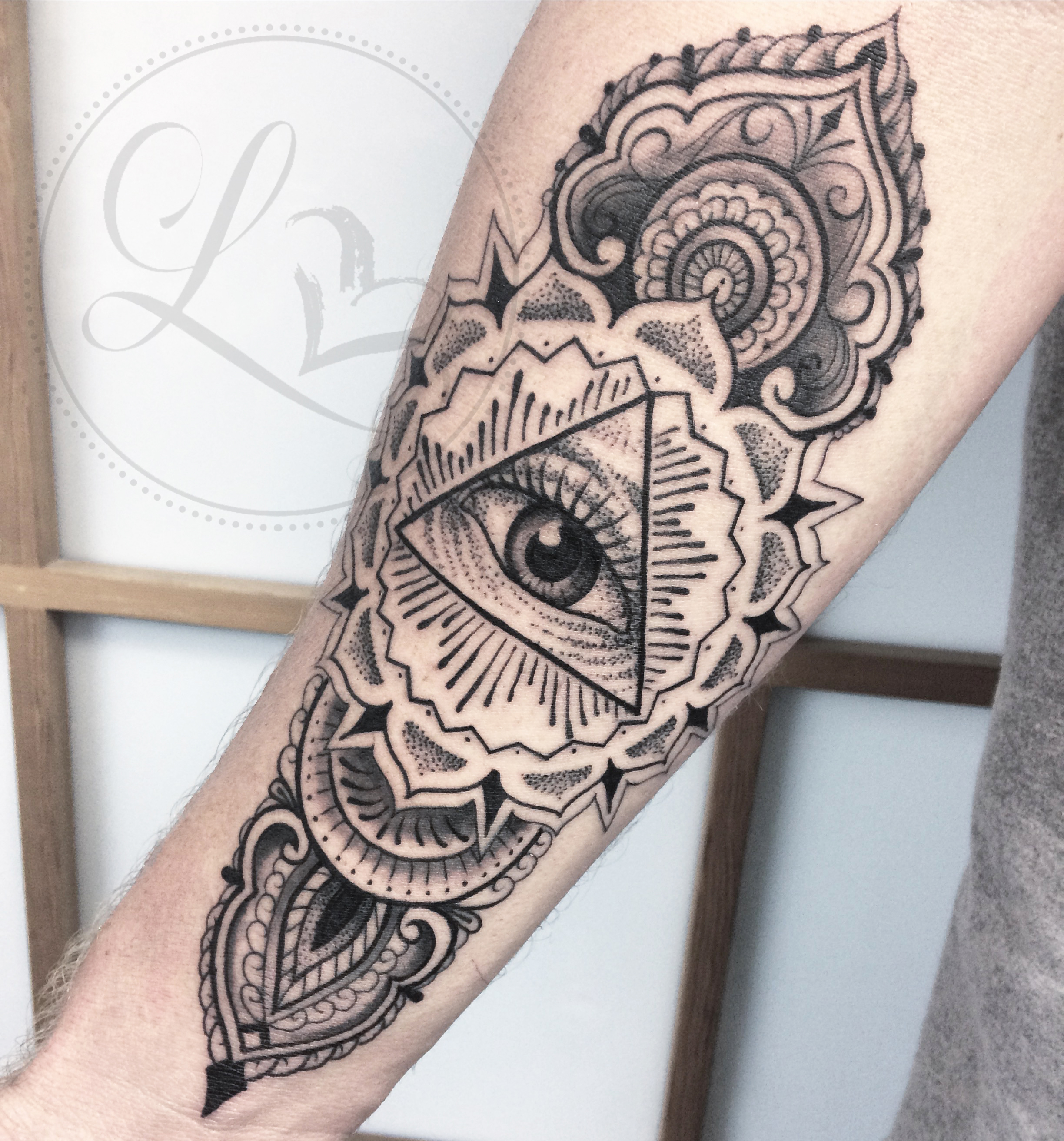 Henna ornamental eye forearm tattoo
