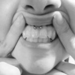 "Smiley" piercing - upper lip frenulum / "web" piercing with an 18g circular barbell - done by Lhena - Queen of Hearts, Wailuku, Maui.