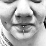 Fresh vertical labret piercing with a 16g gem-topped curved barbell - done by Lhena - Queen of Hearts, Wailuku, Maui. Cheek piercings not by QOH.