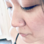 Nostril piercing with a 14k yellow gold real diamond nostril screw, done by Lhena at Queen of Hearts - Wailuku, Maui