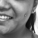 Sideview of fresh cheek / "dimple" piercing with 14g standard ball labret - done by Lhena - Queen of Hearts, Wailuku, Maui.