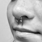 Septum piercing with a 16g circular barbell