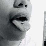 Tongue piercing with a 14g barbell - done by Lhena - Queen of Hearts, Wailuku, Maui.