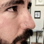 Nostril nose piercing done with a turquoise-dyed howlite cabochon nostril screw