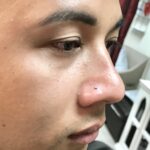 Nostril piercing with a crystal nose stud