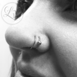 Double hoop nostril nose piercing
